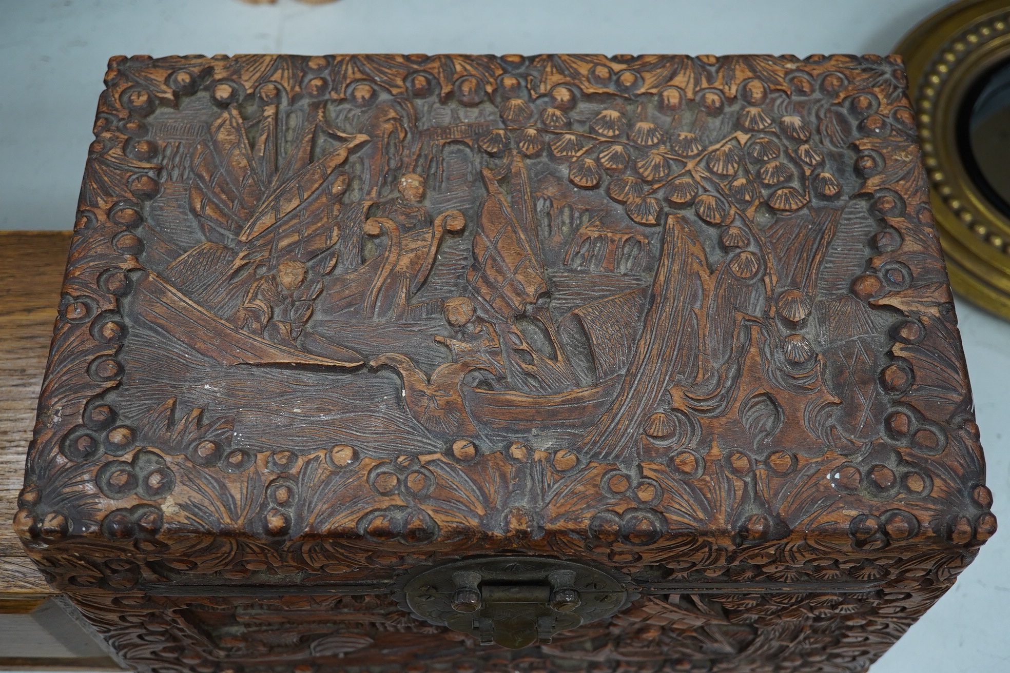 A Chinese carved small camphor box and an oak cased Mahjong set, camphor box 31cm wide, 17cm high. Condition - fair